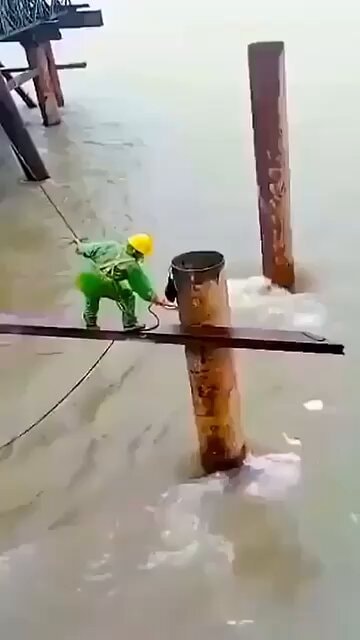 construction worker balancing on plank