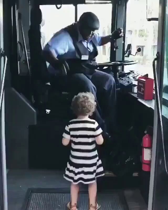 Bus driver dances with young passenger