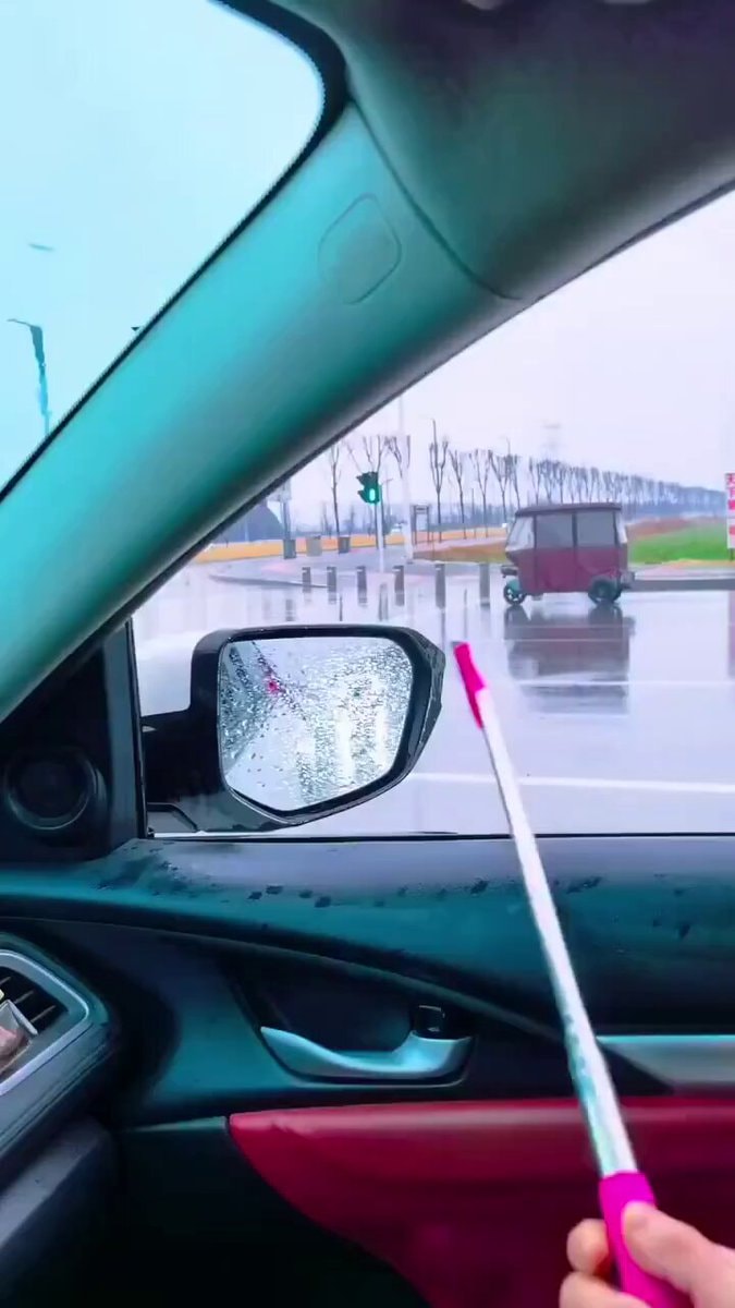 Cleaning car mirror with umbrella 😂