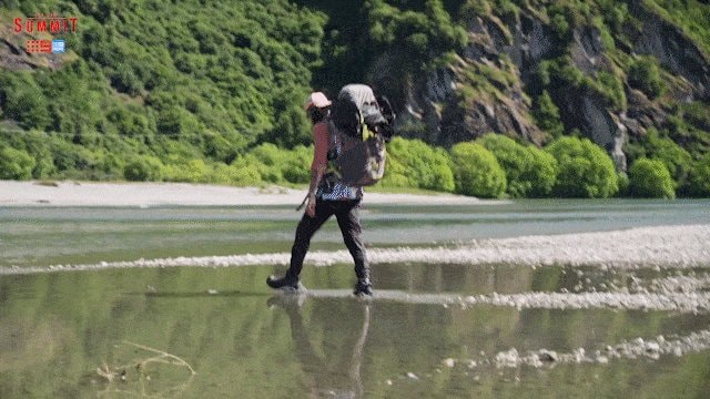 hiker crossing river after max win