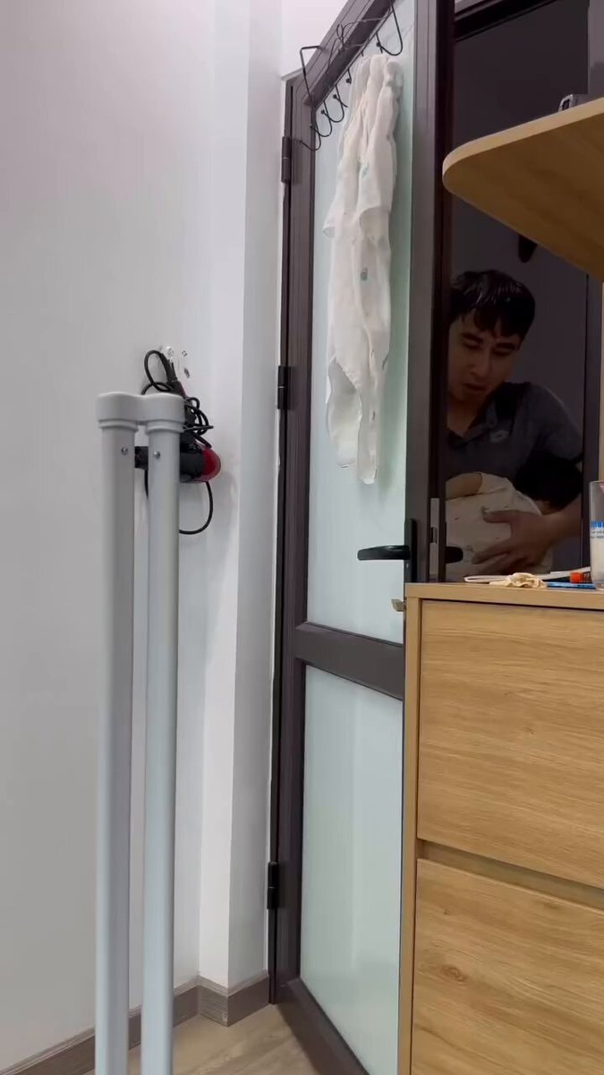 toddler peeking behind arm