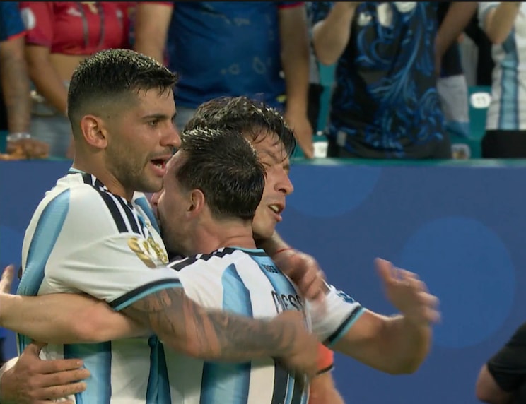 Messi hugs Martinez and Romero