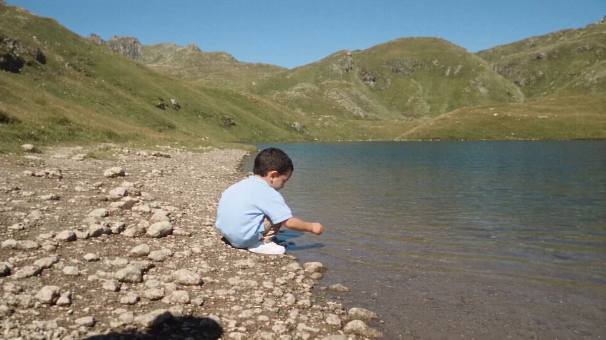 boy by lake feeling happy