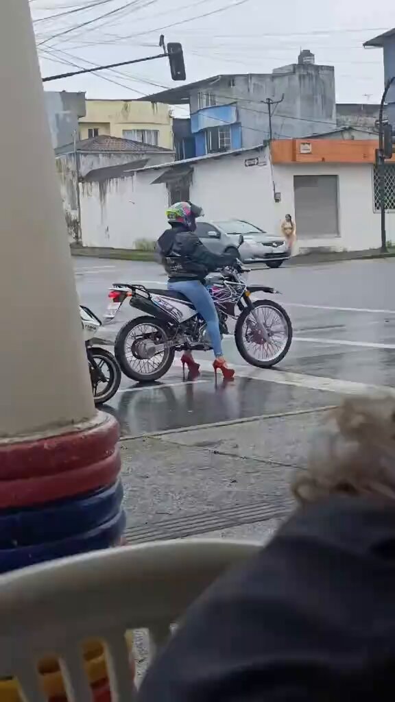woman on motorcycle in high heels