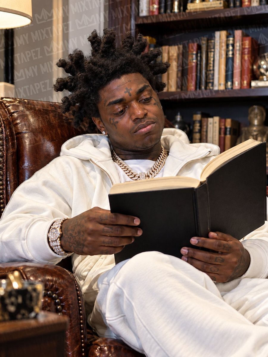 Kodak Black reading in leather chair