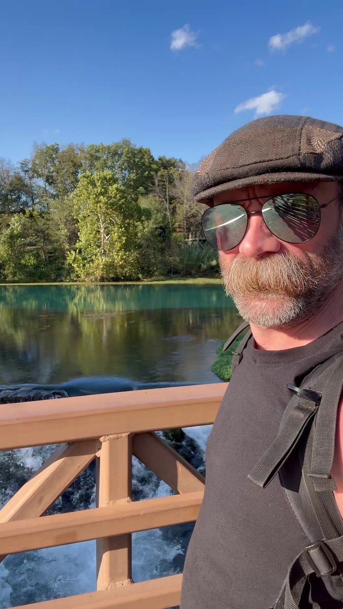 man taking selfie by turquoise water