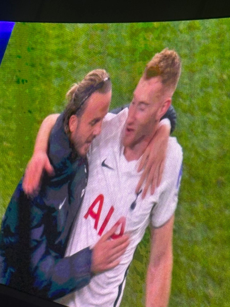 Two soccer players embracing on the field