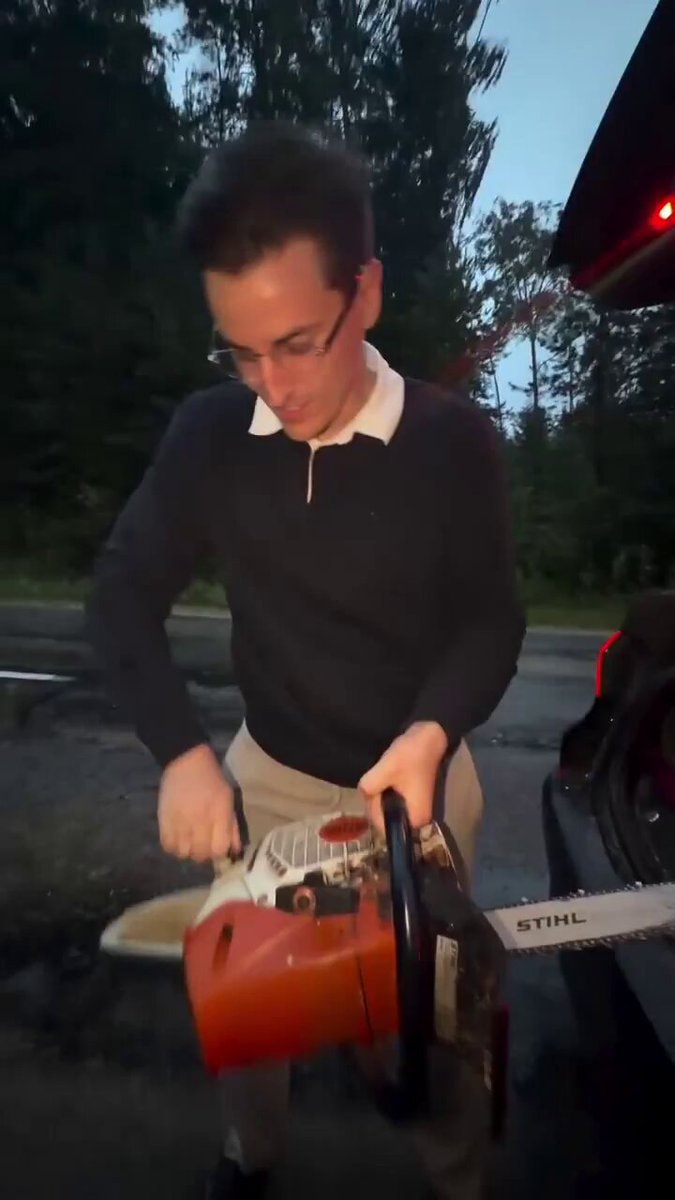 man with chainsaw in car