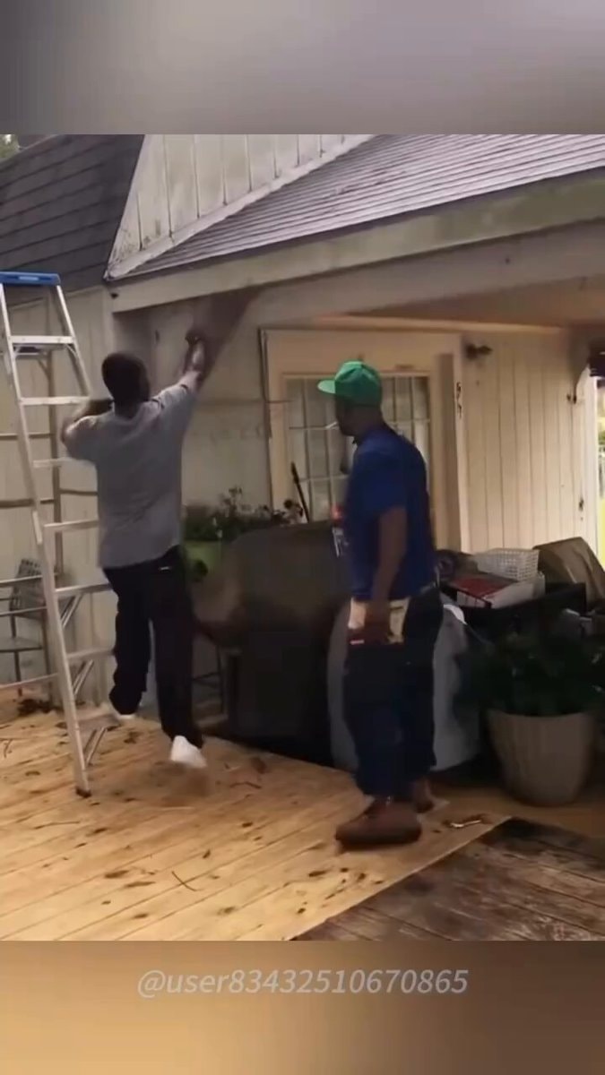 Two men working on house exterior