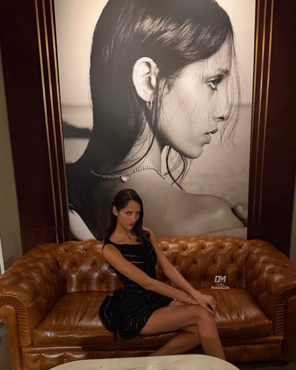 Yasmin poses in front of her own photo