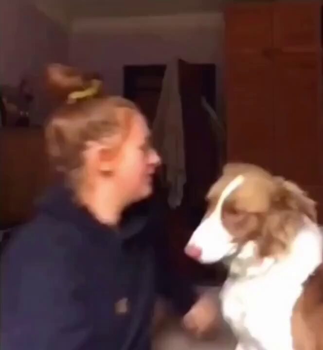 Woman holding dog longer