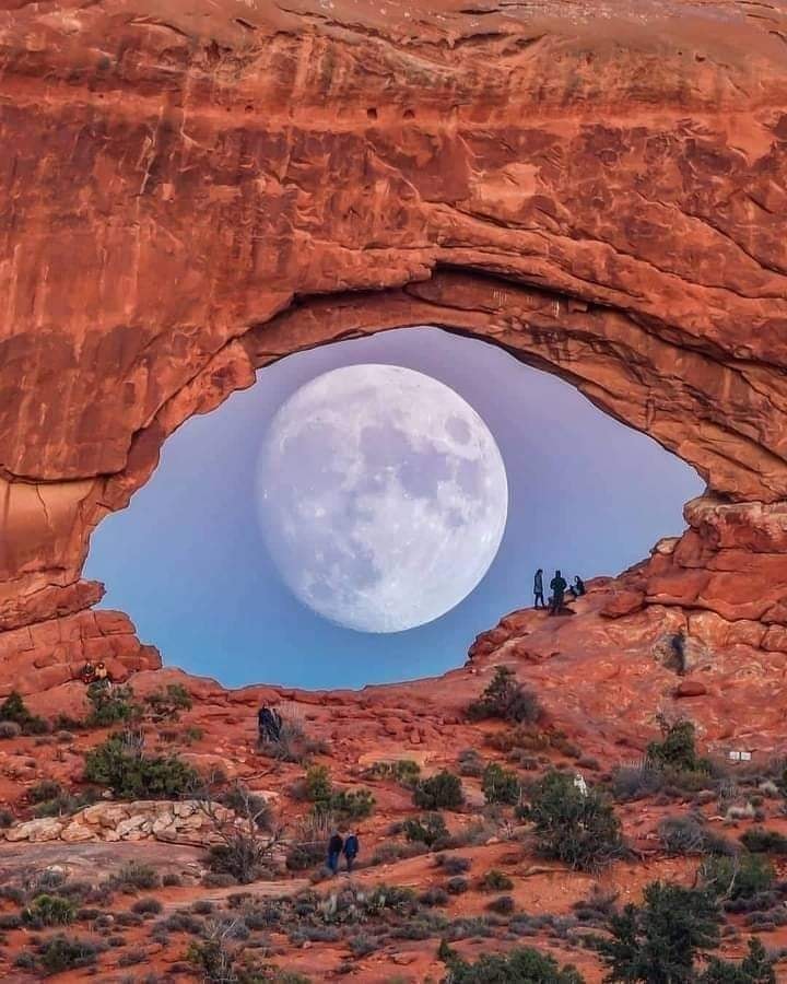 Moon through desert rock arch Moon through desert rock arch
