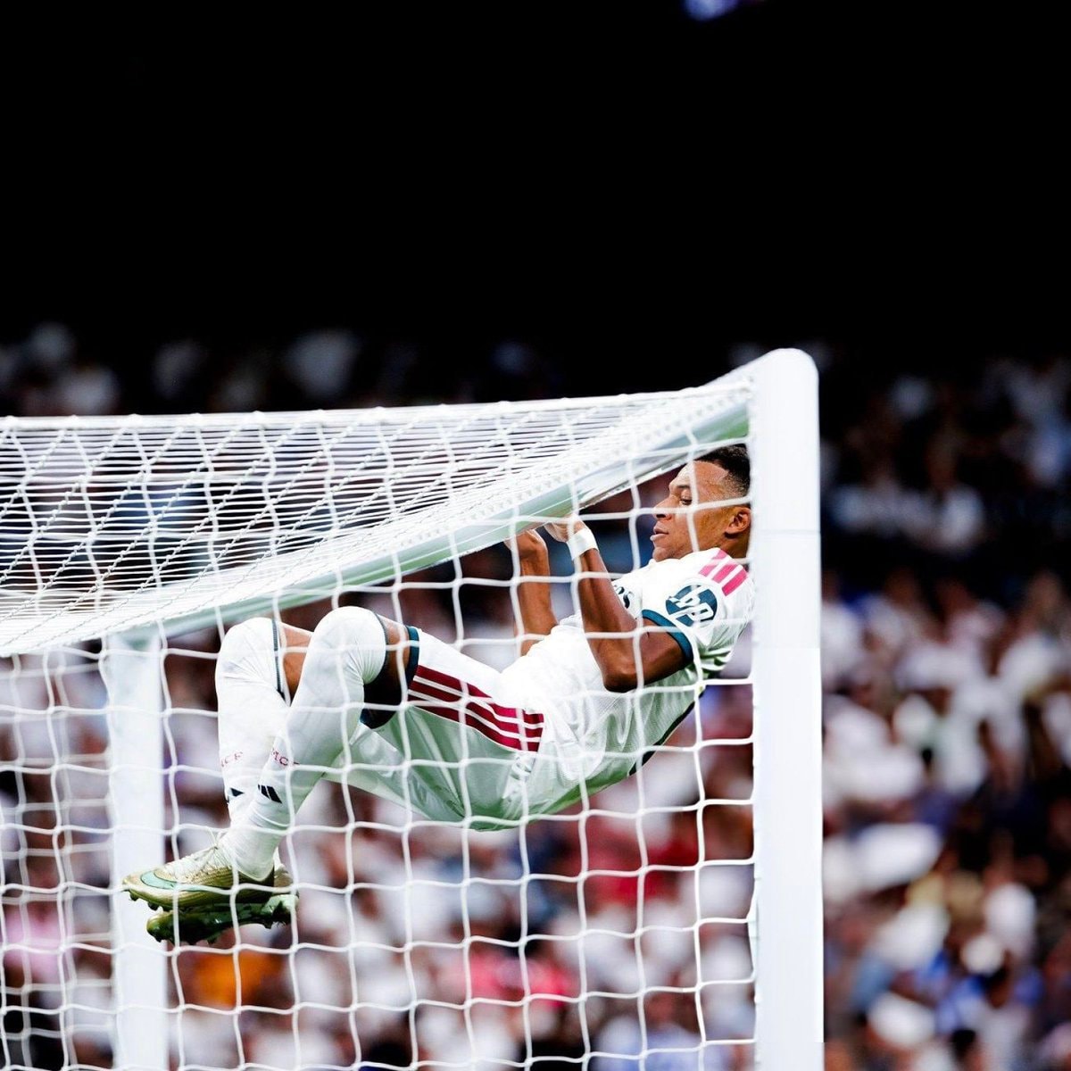 Mbappé hanging from the net