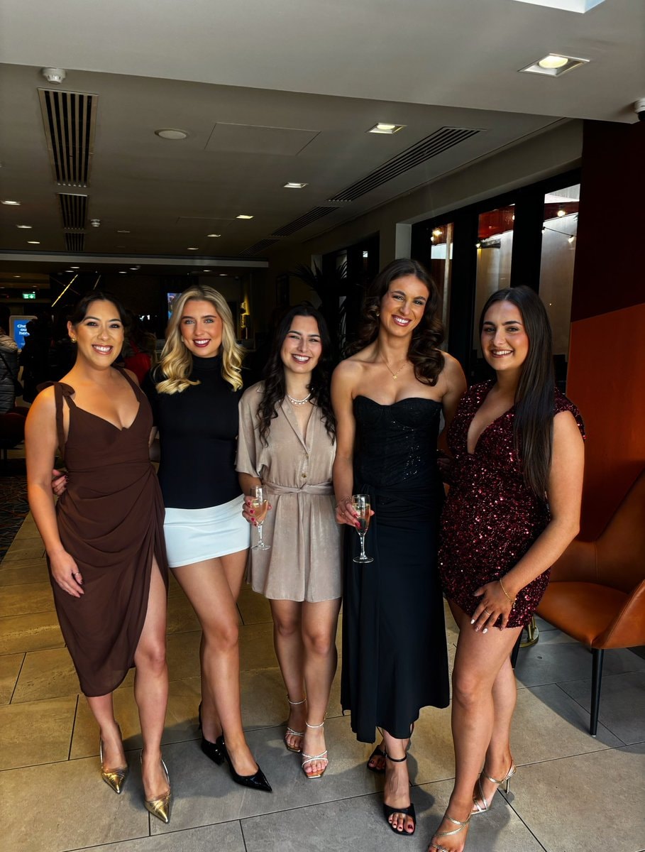 five women pose for a group photo five women pose for a group photo