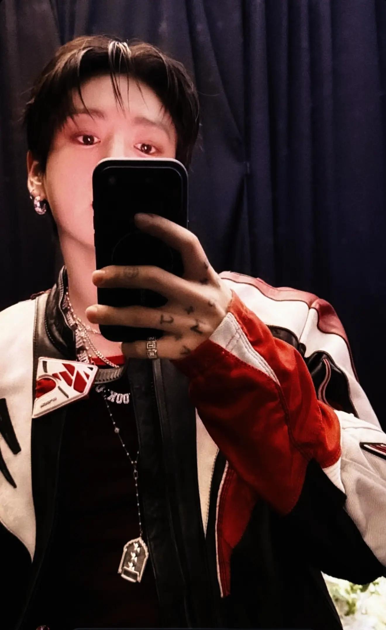 Kook close-up with KING OF THE UNIVERSE necklace (photo 2 of 3)