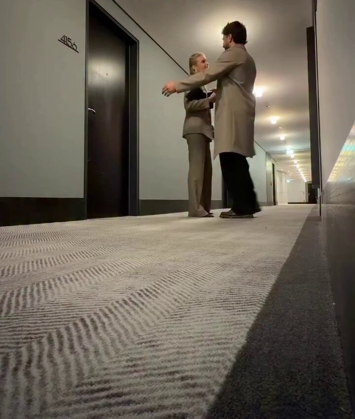 Hotel hallway embrace