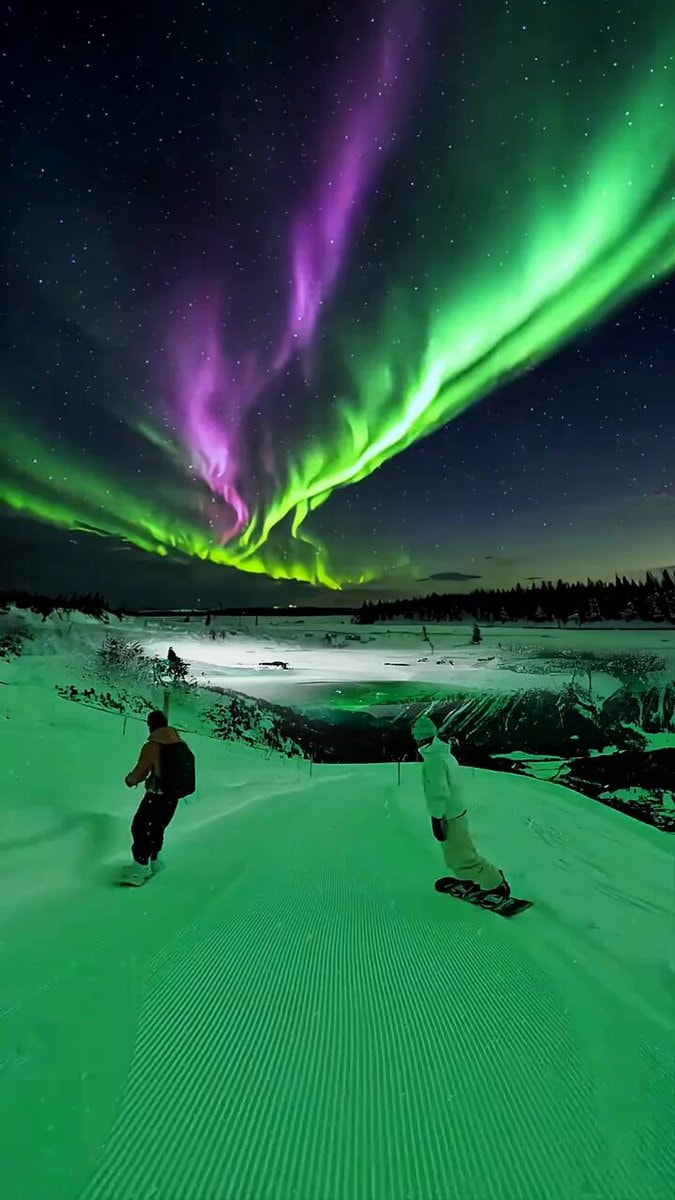 snowboarder under Northern Lights