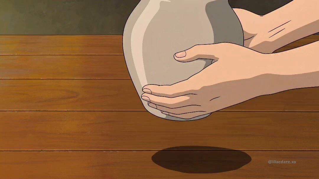 hands holding ceramic pot
