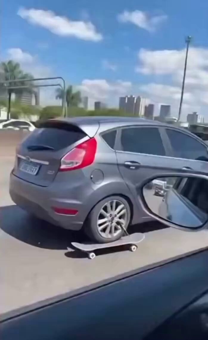 Car with skateboard on rear wheel