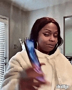 Woman laughing at phone GIF