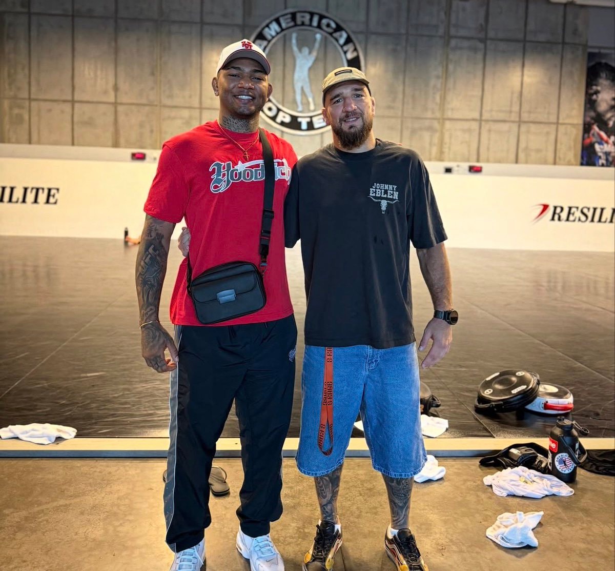 Two men posing in gym