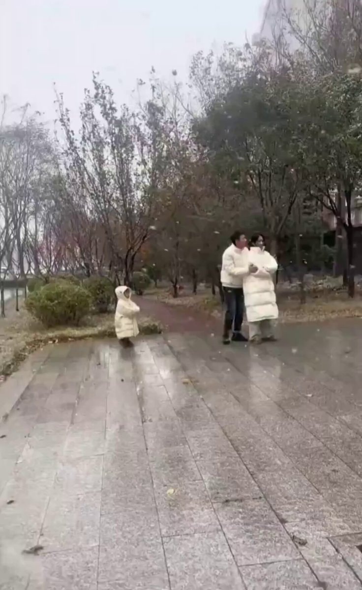 family white coats rainy walk 😂