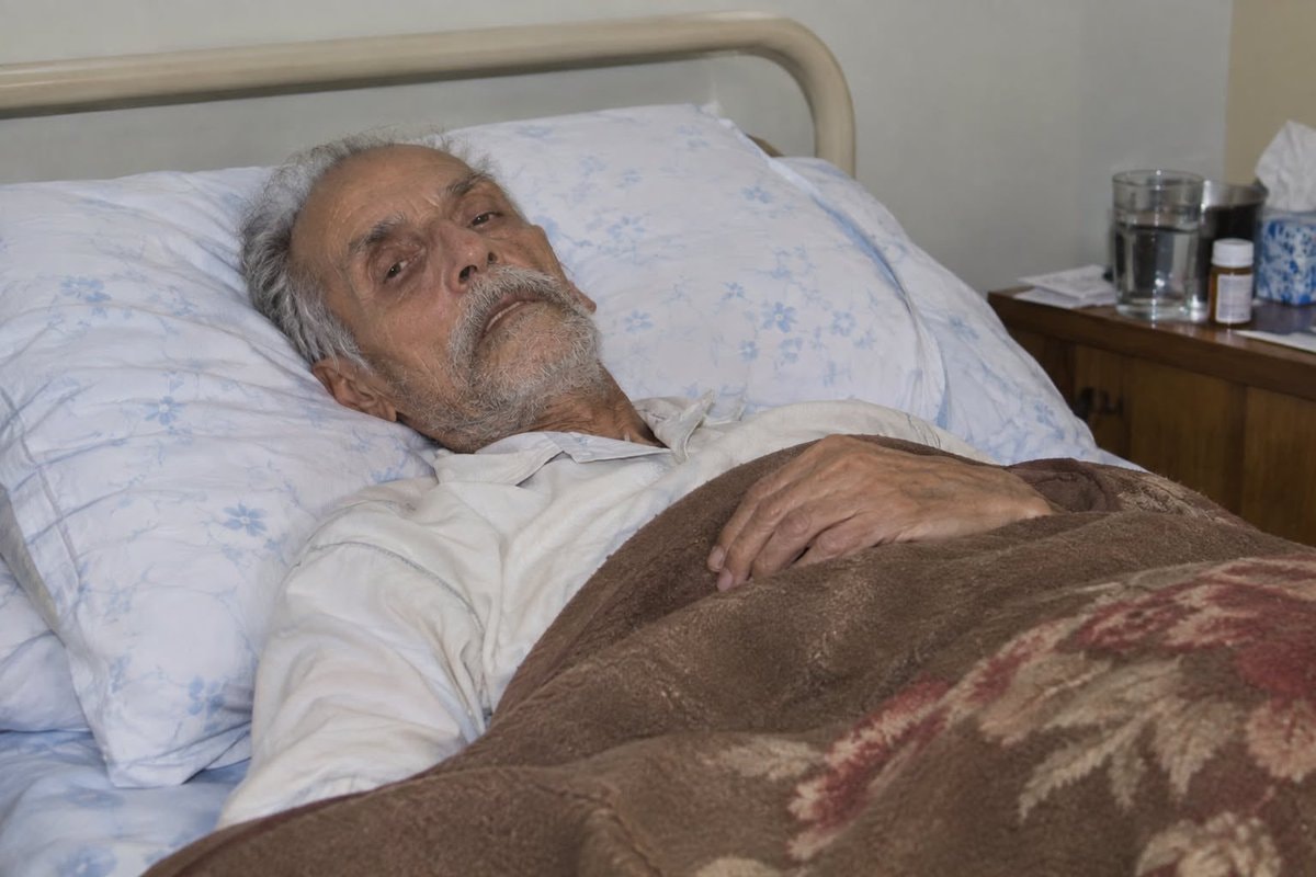 elderly man in hospital bed