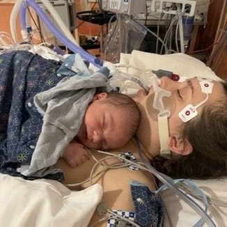 Newborn first hold after coma