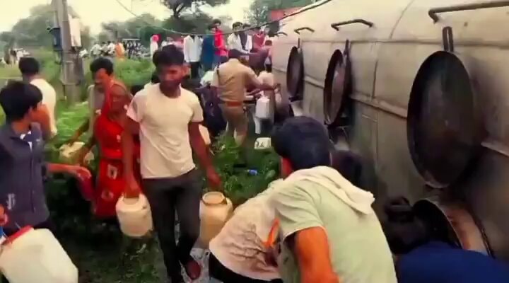 Indian locals collect oil from overturned tanker