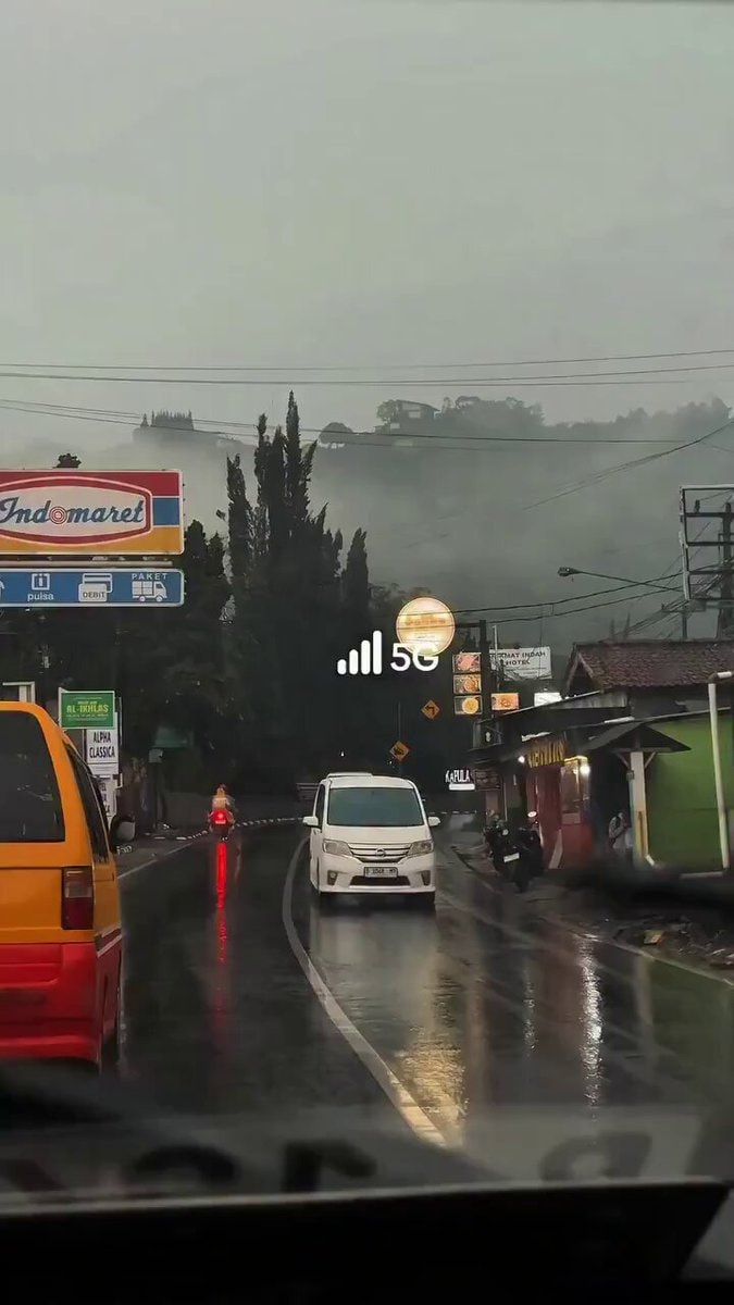 rainy street scene Indomaret 5G