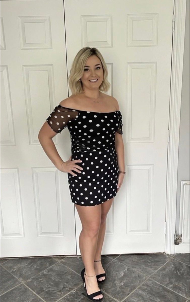 woman posing by white doors