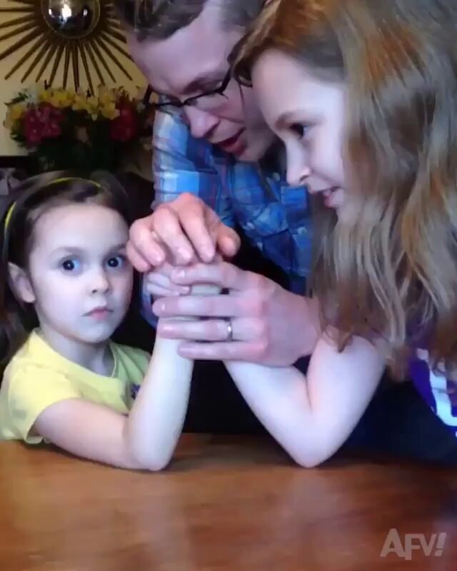 Dad arm wrestling daughters