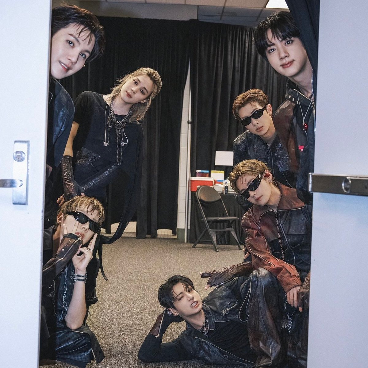 seven men peeking through doorway