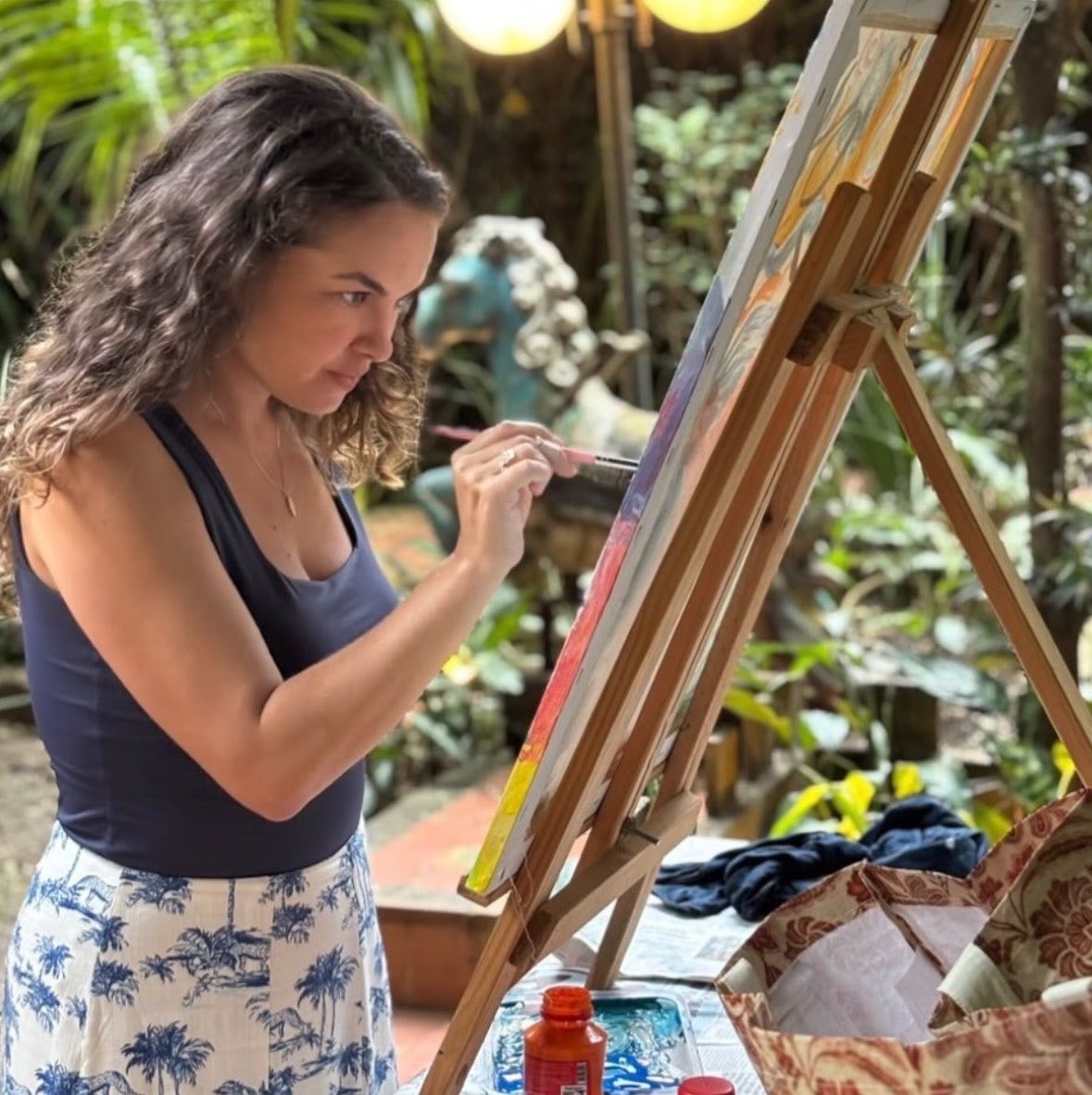 Lua Blanco painting outdoors