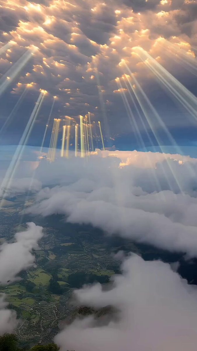 above the clouds sunbeams