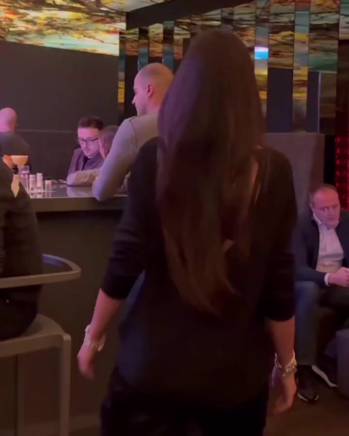 woman walking away in a bar