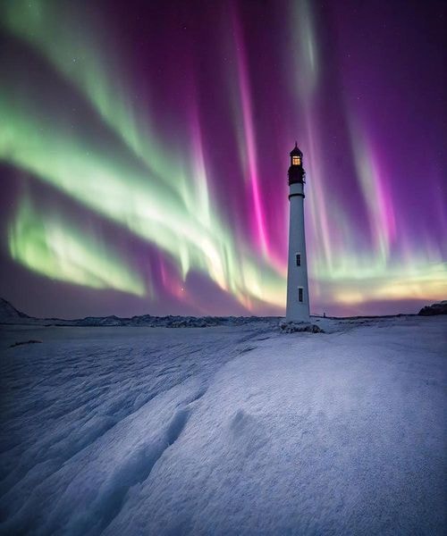 Aurora Borealis over lighthouse