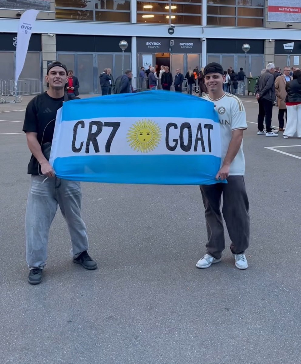Two friends holding up a flag