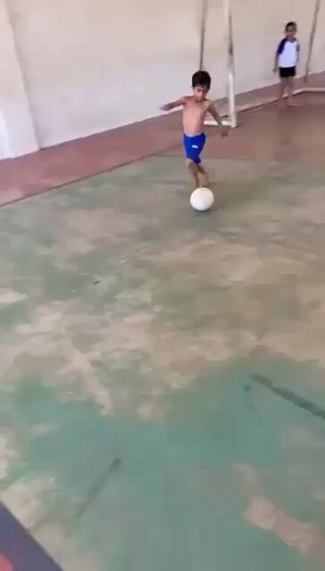 Young boy soccer skills indoor court
