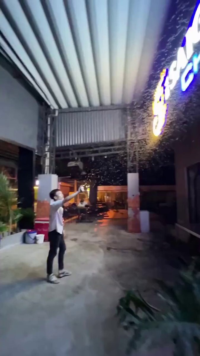 guy reaching for sparks at night