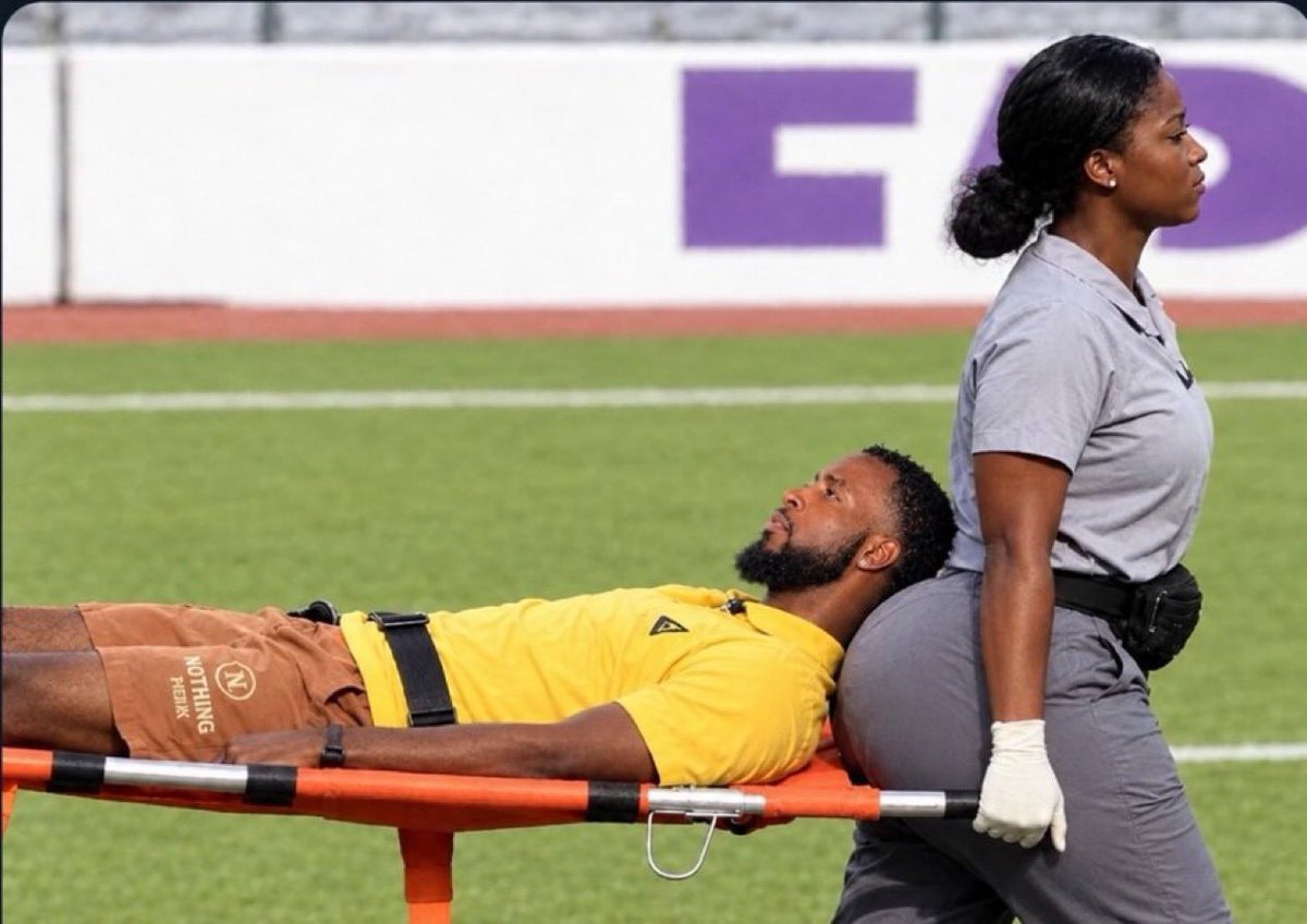 man on stretcher in yellow shirt