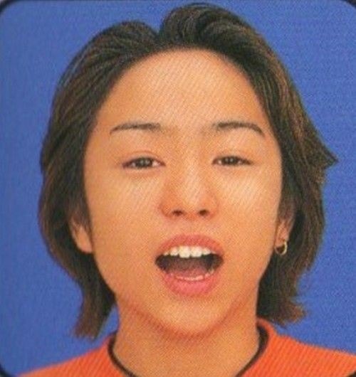 Young Asian person in orange shirt (photo 4 of 4)