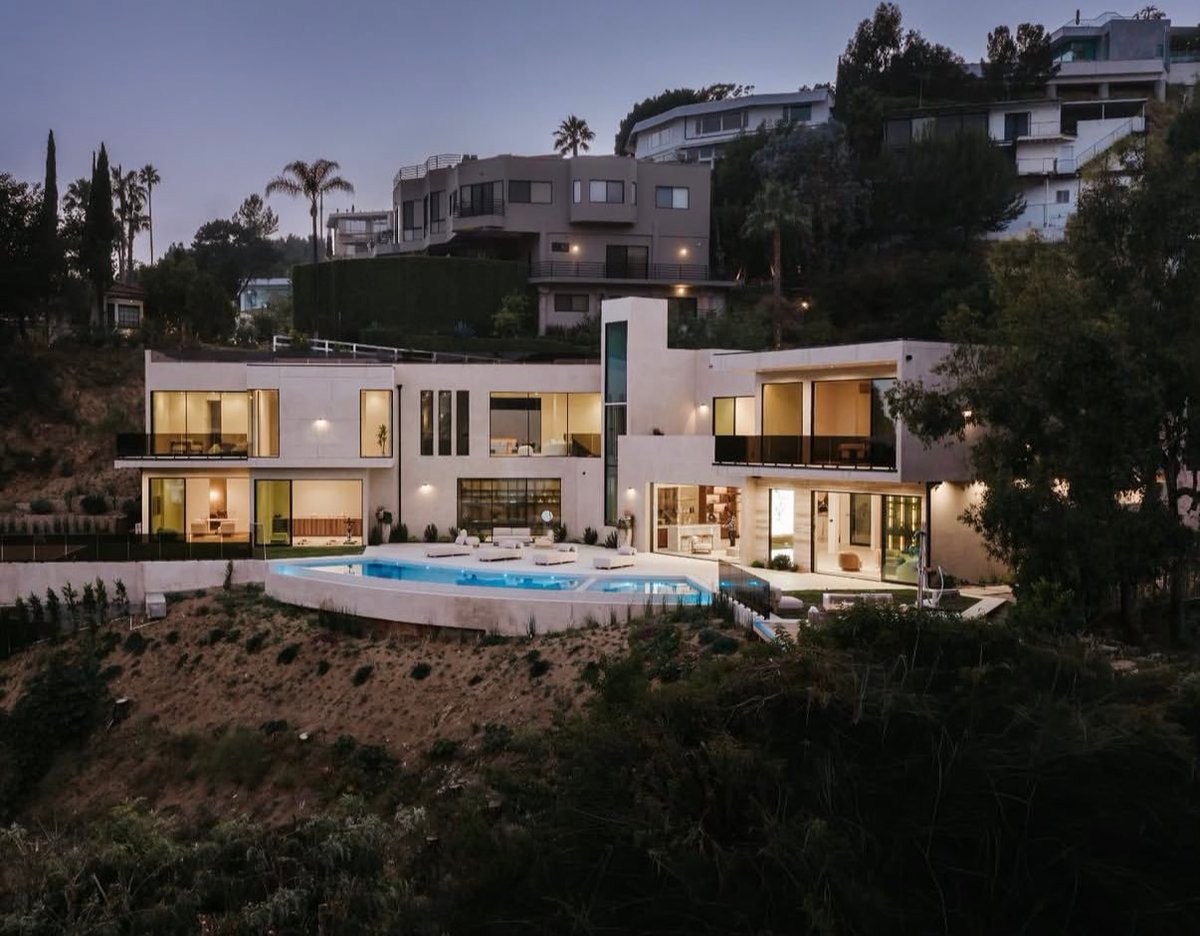 Modern infinity pool mansion at dusk