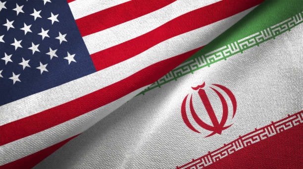 Iran and US flags draped together Iran and US flags draped together