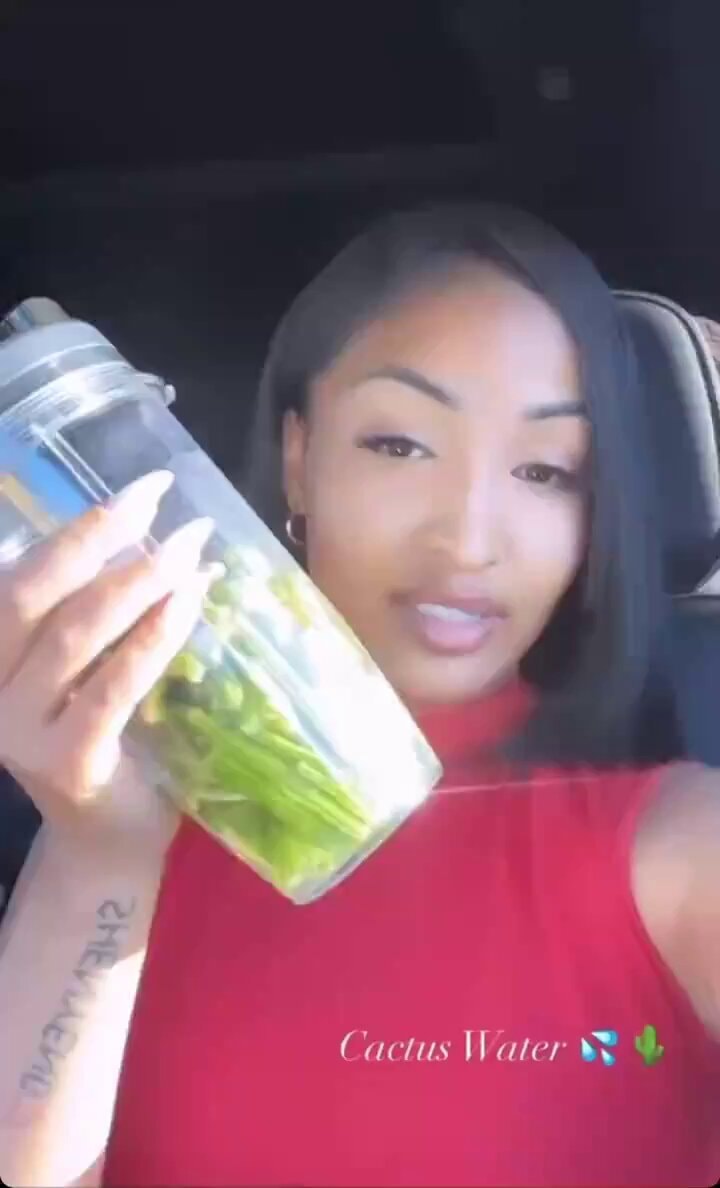 woman holding green shaker bottle