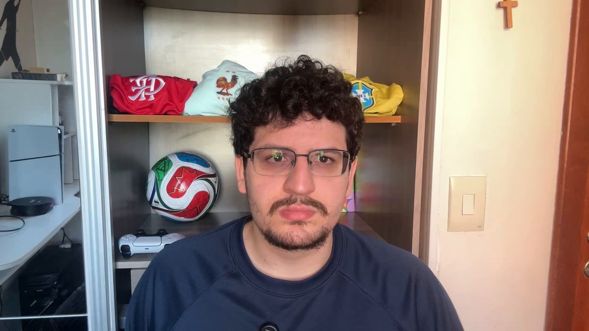 young man with curly hair and glasses