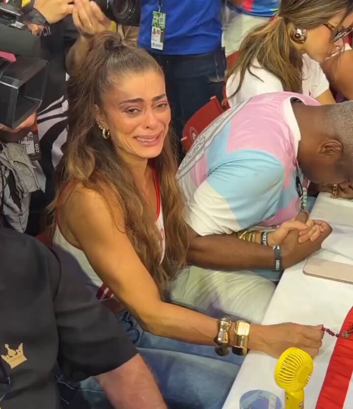 Woman crying surrounded by cameras
