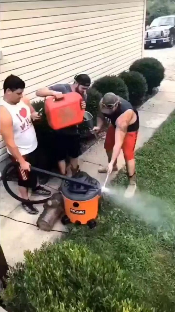 Men with RIDGID shop vac and hose