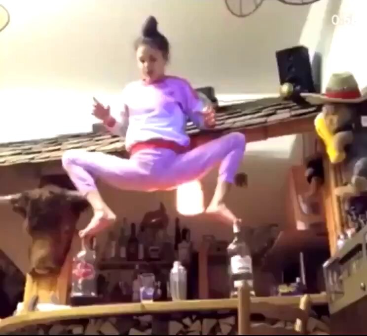 woman split jump over bar