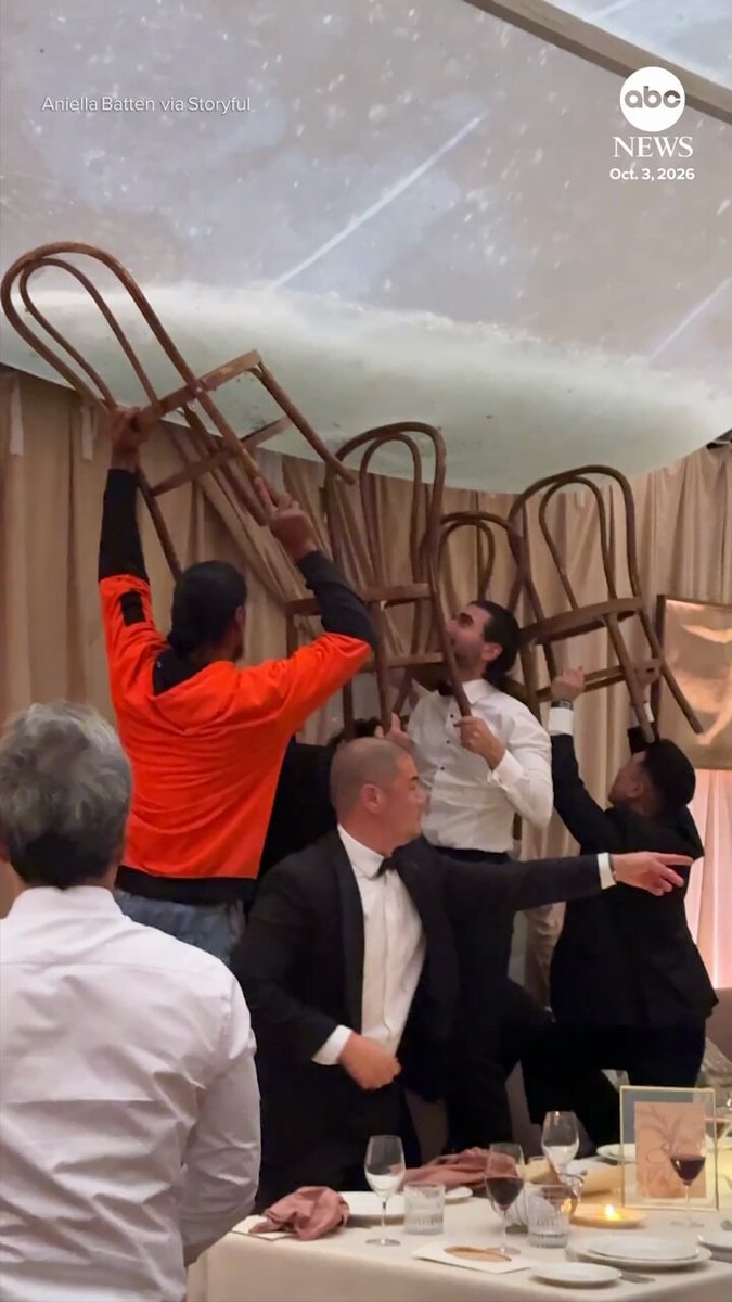 Australia wedding guests block hail with chairs